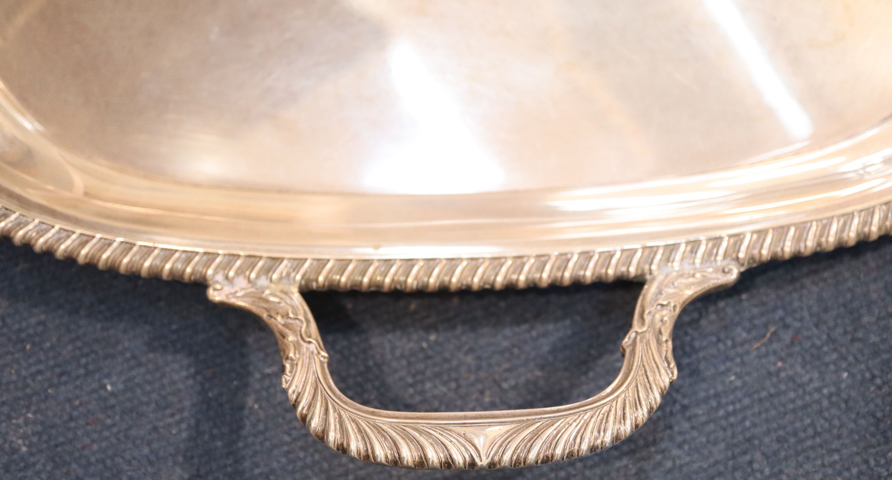 A George V silver two handled tea tray, 64.7cm over handles, 98oz.
